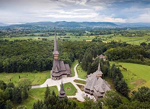 Traditional Maramures neo-gothic wooden church in Sapanta-Peri monastery with highest wooden belltower in Europe, Romania